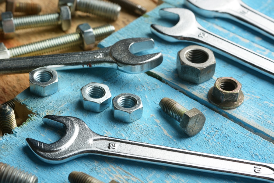 Wrenches and bolts depicting the need for HVAC maintenance.