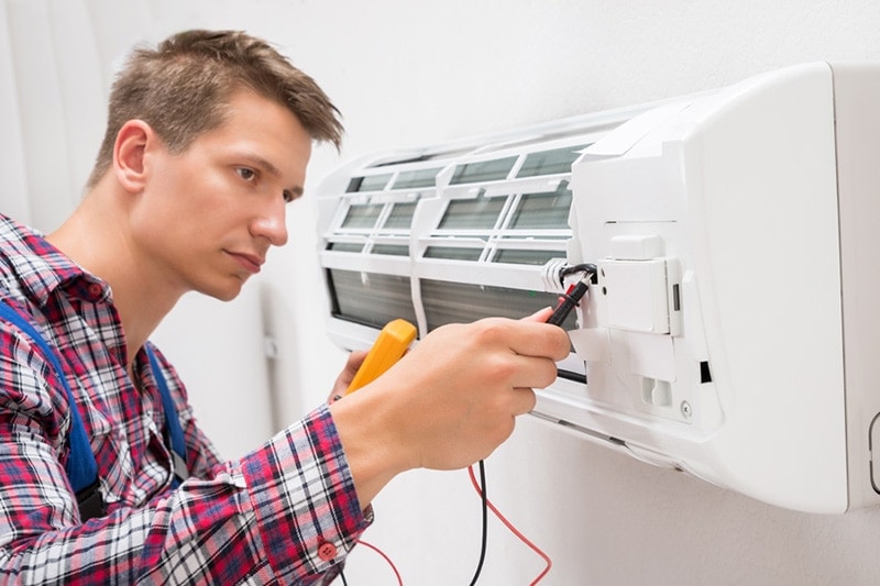 man fixing HVAC unit